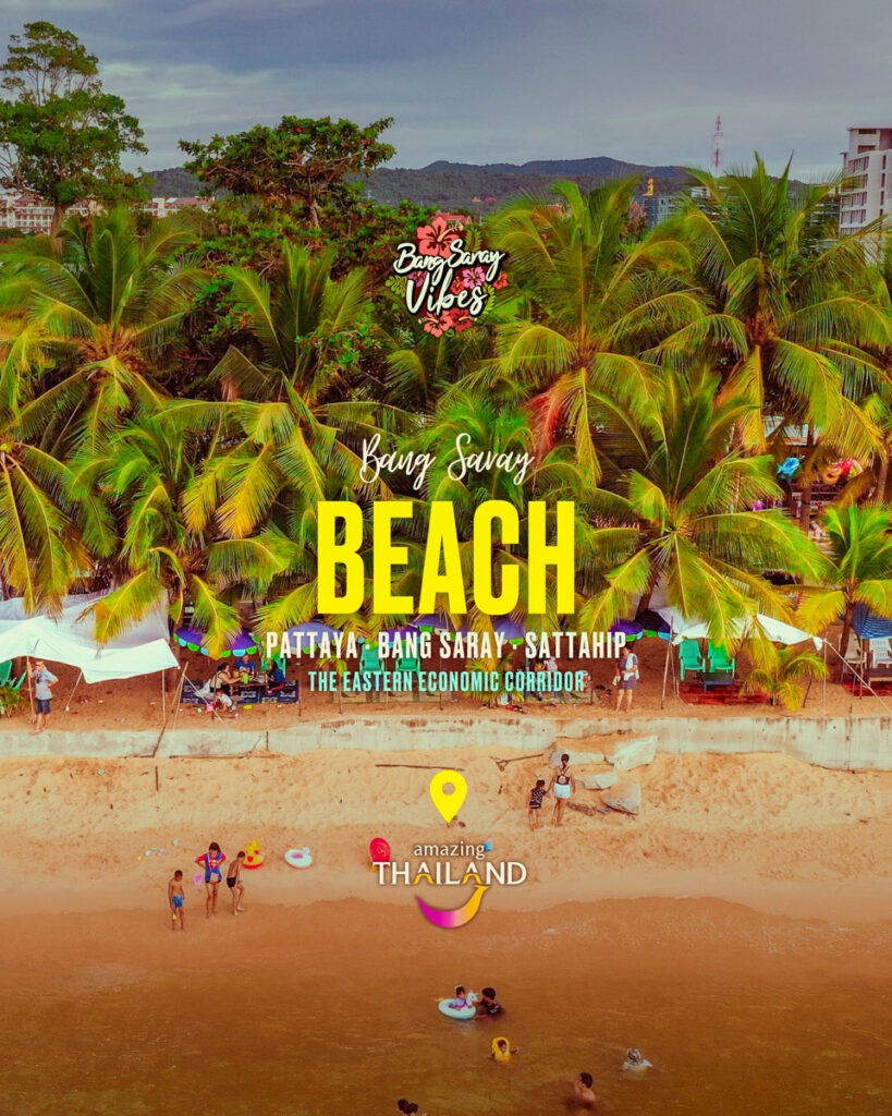 The image shows a beach in Bang Saray, Thailand, with people and trees. It captures a tropical scene with palm trees, the beach shore, and a cloudy sky.