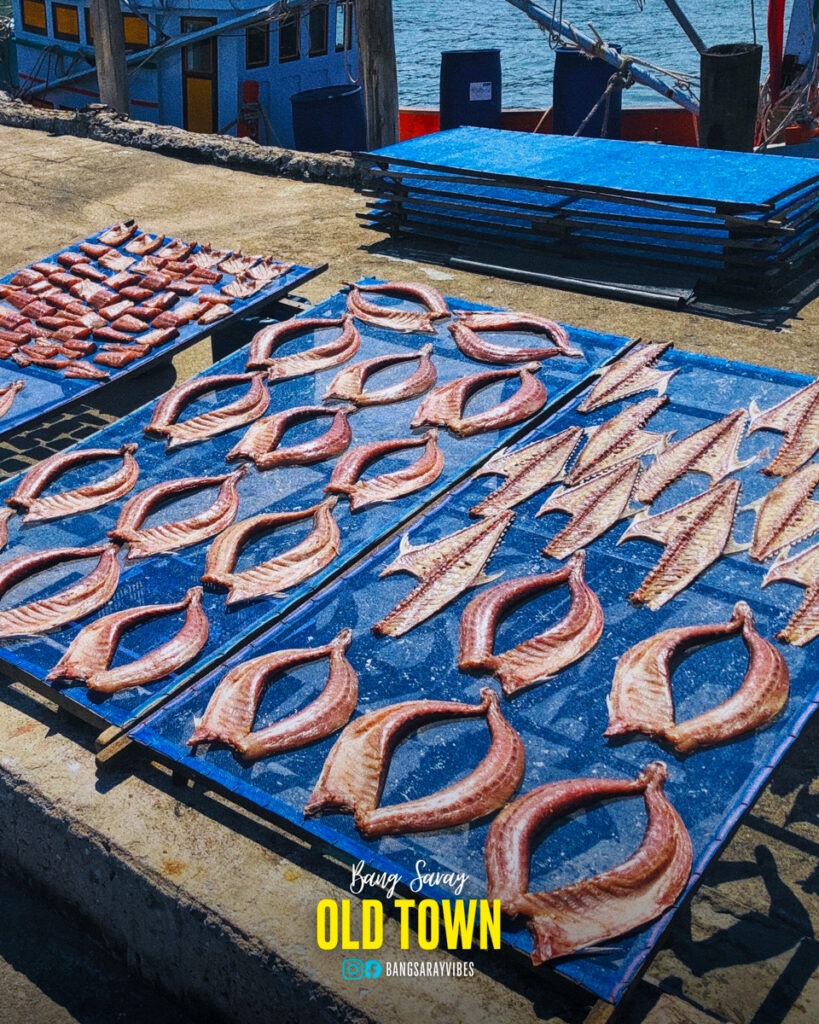 The sight of dried fish scattered along the road at the Old Town fishing pier in Bang Saray village.